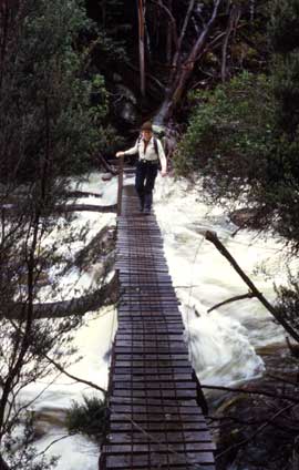 tas-fish_crossing Some time after the journey described in this story, a proper suspension bridge, complet with hand rails, was built across the Fish River. Here, a hiker crosses the Fish in its summer flow.