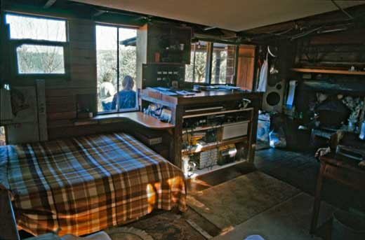 Somewhere to sleep, somewhere to cook, something to play music on... a life's needs so few and simple as to envoke envy. Interior, Simon Flynn's shack, Crater Cove, 1987.