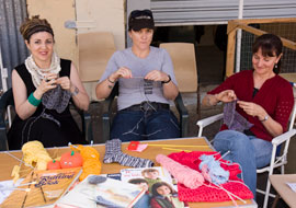knitters2 It might have been a food fair but there was a place for handicrafts, too. Members of a knitters guild get busy.