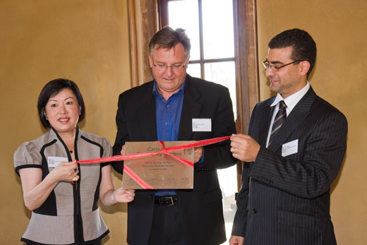 CPCG_opening_ribbon Untieing the ribbon around the plaque to officially open the community garden are (from left) Cr Annie Tang (Deputy Mayor); Rod Logan, Director Planning & Environmental Services and Mayor, Cr Nickolas Varvaris.