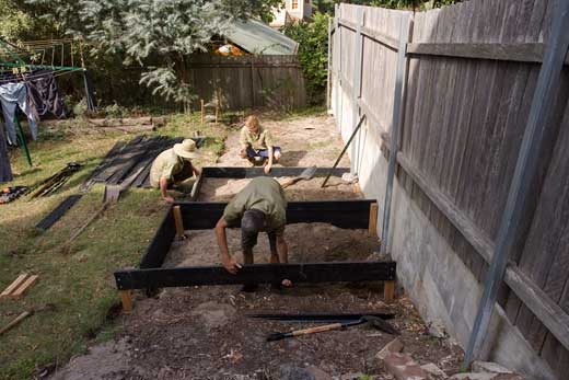 Garden-construction-221209_22 DAY ONE, morning: Construction is underway on the first of the raised beds, with Steve's apprentices working on the second bed behind. The apprentices had joined Steve's business only four days previously.