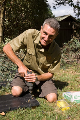 Garden-construction-221209_23 DAY ONE, morning: Rob Alsop drills a board in preparation to bolting it into the raised bed. The board is a recycled plastic, made of old printer cartridges, that has been stabilised against ultraviolet light and leaching. Rob is otherwise an illustrator and trainer. He illustrated Rosemary Morrow's book, An Earthkeepers Guide to Permaculture (https://staging.pacific-edge.info/617/) and A Good Home Forever (https://staging.pacific-edge.info/649/) and teaches permaculture design.