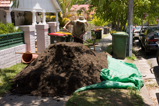 Garden-construction-221209_51 DAY ONE, morning: The five cubic metre stockpile of organic growing medium blocks the Sully Street footpath. The medium is reprocessed, composted green waste from the council green waste collection.