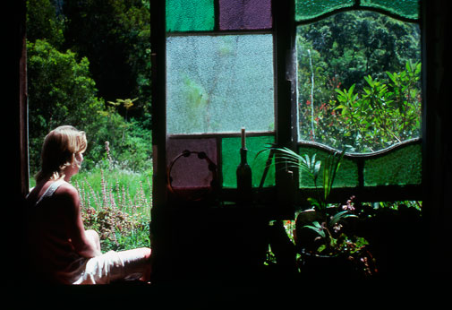 Tyalgum_Fiona&stained_glass Fiona takes a moment to herself at the cow bails. The bush behind rises steeply with the slope to join the Tweed Range.