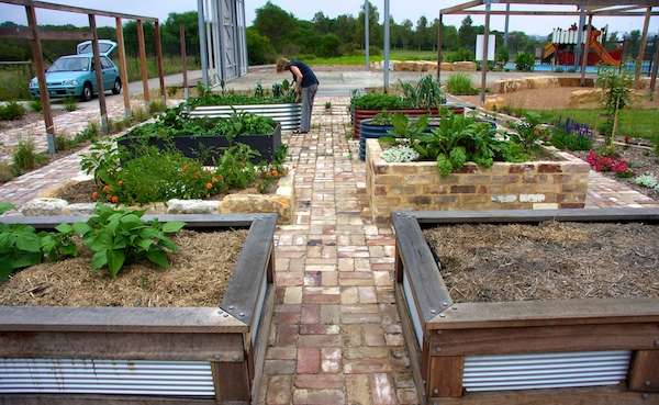 PIG3 Hard surfaces in the garden are made of recycled brick and crushed gravel for ease of maintenance and durability..