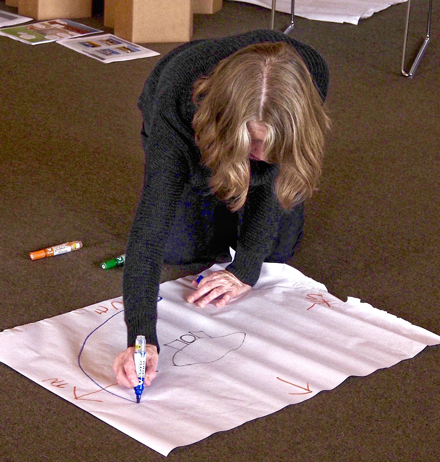 Fiona Campbell sketches a diagram while discussing site analysis.
